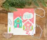 Handmade Christmas card in pink, blue, green and white. Featuring 2 gingerbread houses and saying From our home to yours.