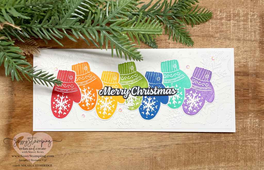 Handmade slimline card with a rainbow of mittens saying Merry Christmas